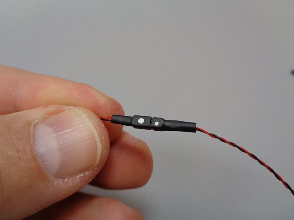 As shown in the second photo, each plug has a white dot on one side of its connector.  Match this white dot to the white dot on the wire from the boat lantern, and connect all five boats as shown in the third photo.