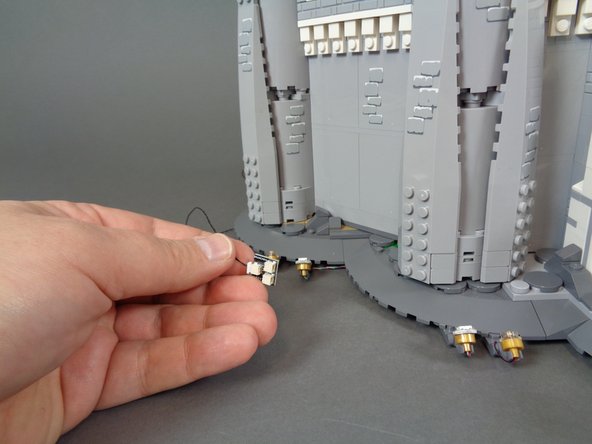 The second and third photos show the 2-wire cable connected to the BRANCH04 adapter board, and the red line in the third photo shows the approximate length of cable that should extend out from under the castle base to allow the main power supply to be connected.