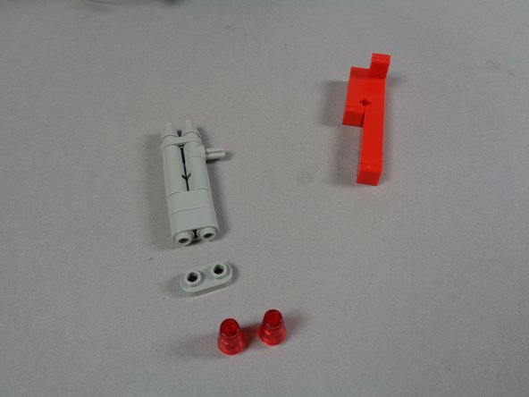 As shown in the photos for this step, carefully remove the right rear tail light and take apart the pieces as shown in the third photo.