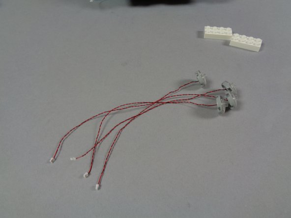 As shown in the first photo for this step, you should now have LED lights mounted inside all of the top four headlights.