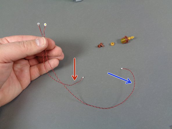 As shown by the red and blue arrows in the first photo, there are LED lights with two different lengths of wire included in the bag.  You will use two LED lights with longer wires for the front torches.