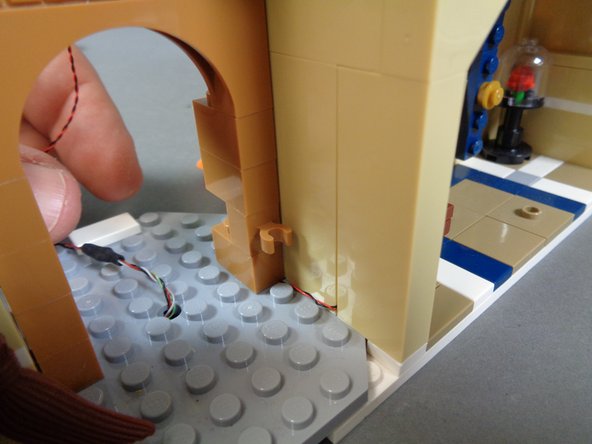 If you chose not to complete the disassembly of the front of the castle, the candelabra light wire will run directly into the kitchen.