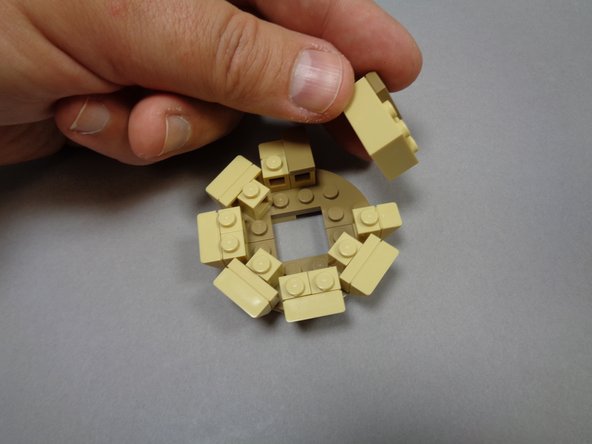 As shown in the second and third photos, you will now remove the 2x3 tan brick from the smaller top tower section.