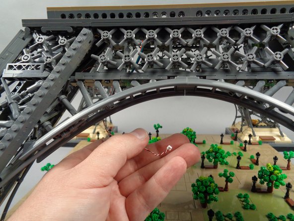 As shown in the first photo for this step, you should now have one control wire hanging loose inside your tower base.