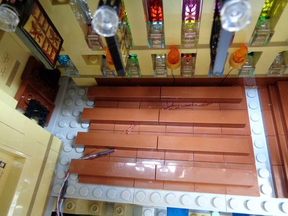 Carefully re-attach the last row of benches.  When you are done, the wires should run as shown in the third photo.