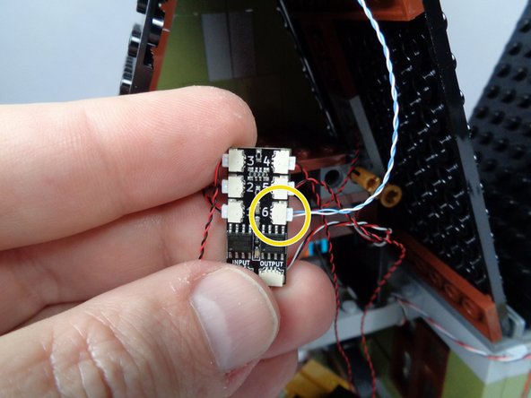 As shown by the yellow arrow in the photo for this step, connect the rooftop lightning LED light to plug #6 on the third BRANCH06X adapter board.