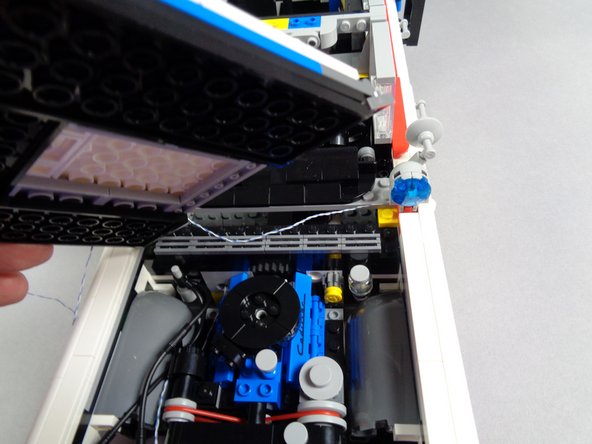 As shown in the third photo, carefully remove the hood and the two plates holding it in place.