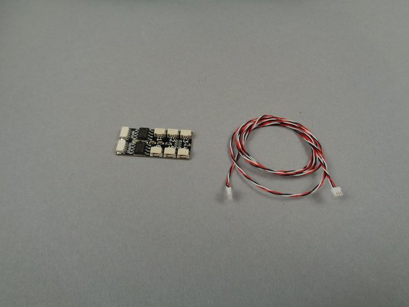 As shown in the first photo for this step, remove the BRANCH06X driver board and its 3-wire connecting cable from the small pink bag included in Bag 2 of your light kit.