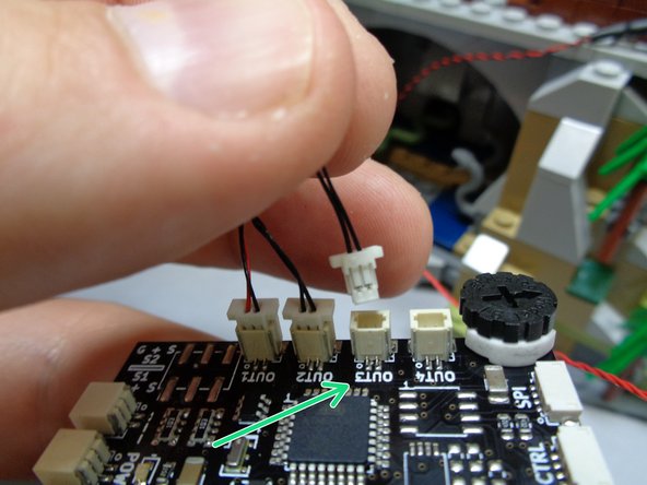 As shown by the green arrow in the first photo, connect the cable from the main hall lights to the plug labeled &quot;OUT3&quot; on the TRUNK08 master controller.