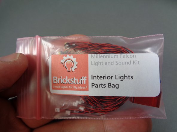 Begin installing the rear interior lights by removing the top door frame from the rear interior room as shown in the third photo.