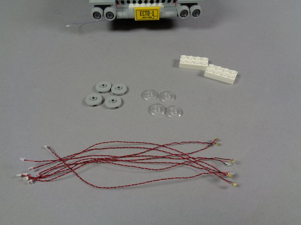 As shown in the third photo for this step, take the eight warm white Pico LED lights out of the &quot;HEADLIGHTS&quot; bag.