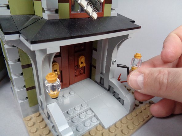 As shown in the first two photos for this step, remove the two front porch lights from your mansion.