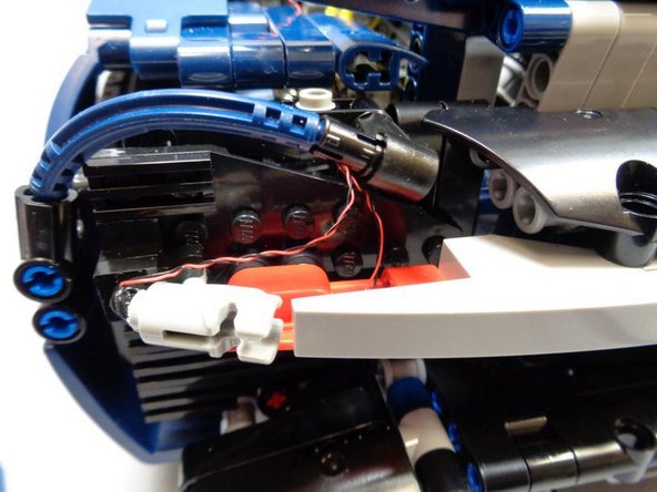 The photos in this step show some tips for routing the wires for both the left and right rear tail light &quot;blaster&quot; parts.