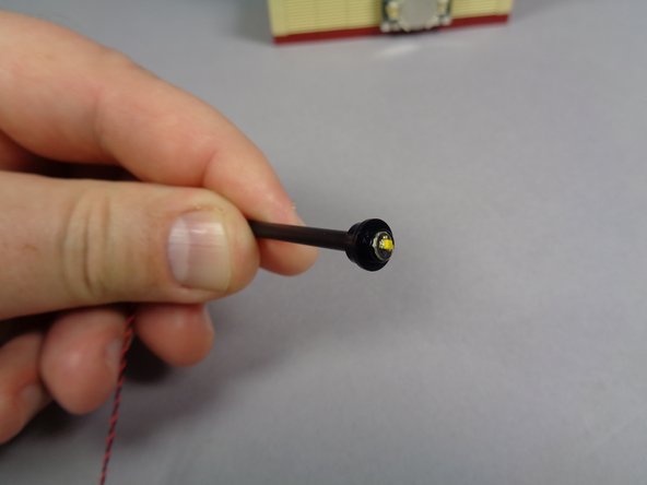 As shown in the second photo, carefully bend the round LED light board so it sits flat at the top section of the tubing.