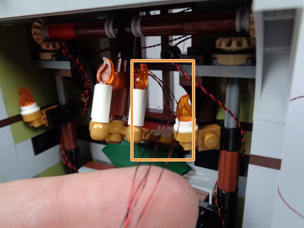 As you are re-attaching the chandelier, be careful that the light wires do not get caught in the black Technic connector piece.