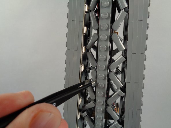 As shown in the second and third photos, because of the limited extra space at this level of the tower, you will need to re-position some brace elements in order to make room for the LED lights and the strip.