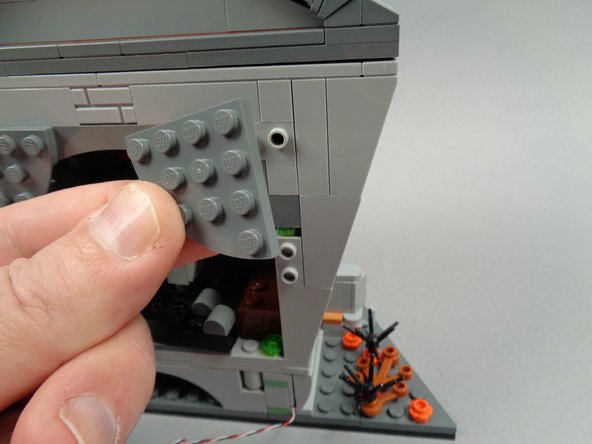 As shown in the third photo for this step, remove both sections of the town hall roof.