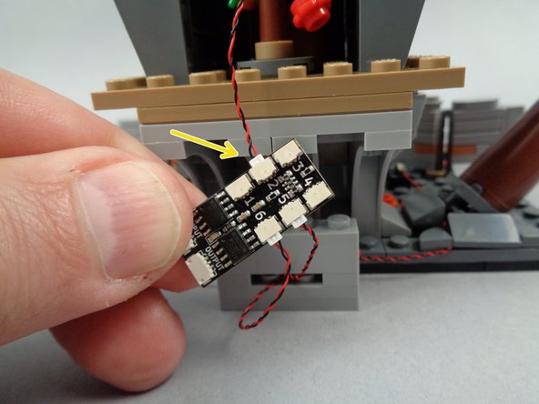 As shown by the yellow arrow in the first photo for this step, connect the wire for the yellow front door light to plug #2 in the BRANCH06X driver board.