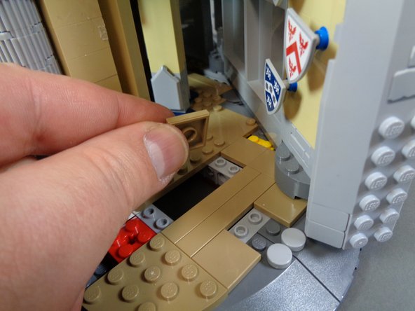 As shown in the second and third photos, take the 2x2 tile you removed in the previous step and attach it to the top of the open space created by removing the two long tiles as shown by the green square in the third photo.