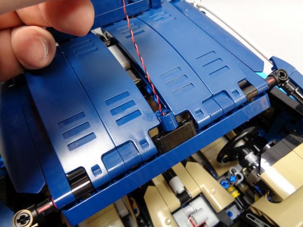 Re-attach the mount assembly to the roof of the Bugatti as shown in the first photo.