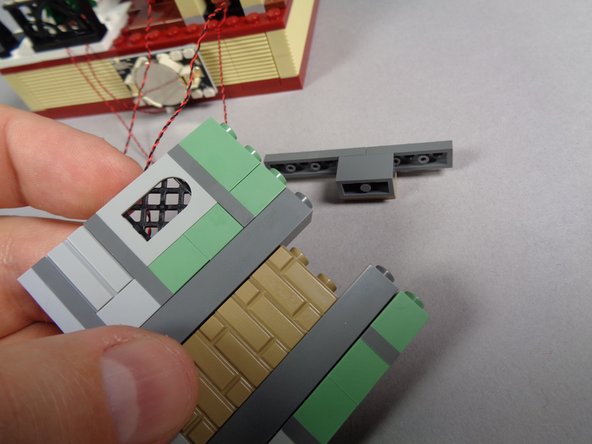 As shown in the second photo, remove the top section of the fireplace back so there is space for the candle light wires to pass through.