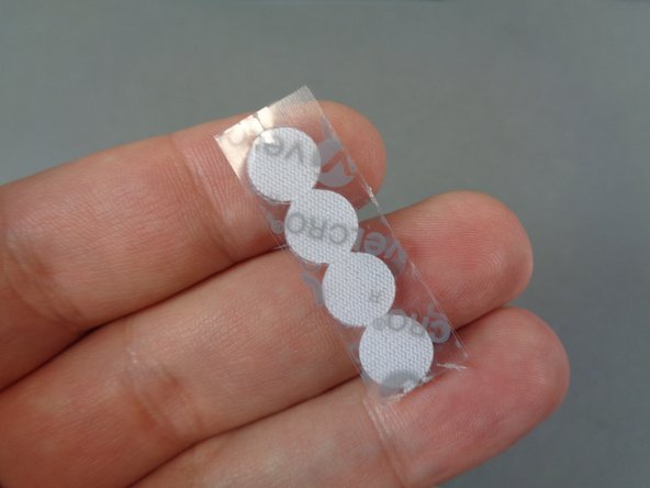 As shown in the first and second photos, take the four Velcro dots from the &quot;Lower Level Lights and Parts&quot; bag and stick them on the back section of the castle tower as shown in the second photo.