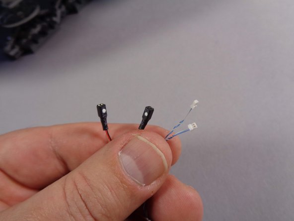 Inside your Main Parts bag in the upgrade kit, there are two conversion cables, as shown in the second photo.  These connect to the black plugs of the laser cannon lights and change the connectors so they will fit into the BRANCH09 adapter board.