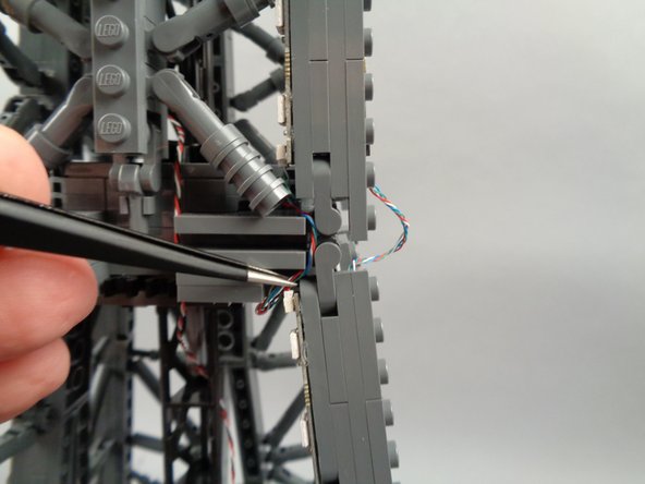 As shown in the photos for this step, you can use the tweezers to tidy up any visible sections of wire connecting the 17-LED sections and 20-LED sections of both light strips.