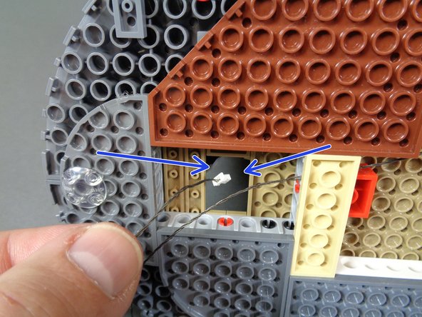 The blue arrows in the third photo show the hole through which you will feed the 3-wire cable.  Pass it all the way through so there is no slack left underneath the castle base.
