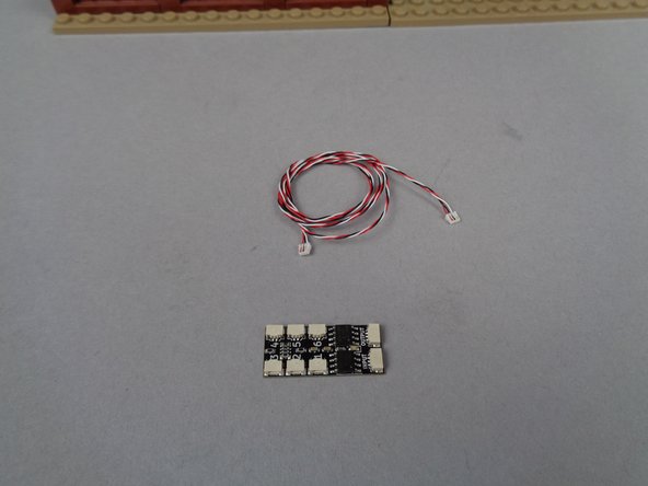 Inside your BOX #3, you will find a third BRANCH06X adapter board and a long 3-wire connecting cable, as shown in the photo for this step.  Take both parts out of their bag.