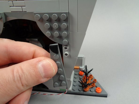 As shown in the first two photos for this step, remove the curtain pieces from the right rear side of the town hall.