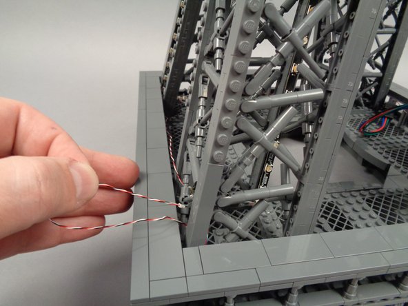 Next you will route the control cable connected to the fourth adapter board back toward the first pillar.  There you will ultimately connect it to the inter-level connecting board.