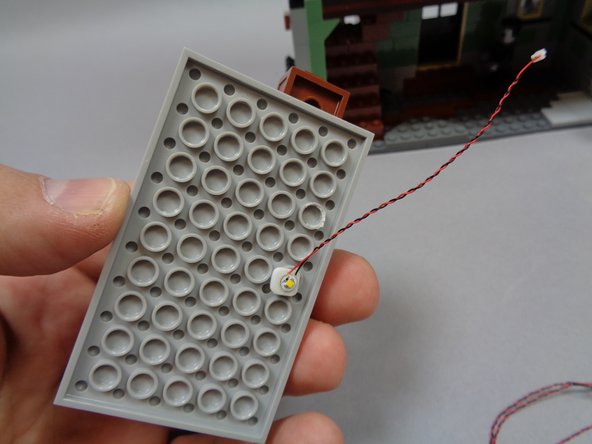 As shown in the first photo, mount the warm white Pico LED light to the underside of the attic floor section you removed earlier.  Make sure to attach the light in the center, to one side as shown.