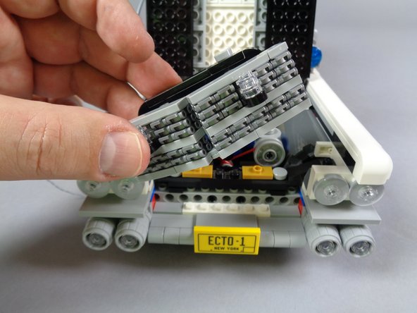 As shown in the three photos for this step, carefully remove the entire front grill assembly.  Make sure the entire piece comes out, including the black pieces behind the grille that hold the two grille strobe lights.