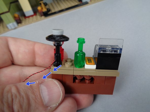 As shown in the second photo for this step, assemble the top of the lamp using three parts from the LEGO parts bag from BOX #1: