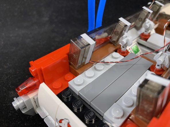 As shown in the second and third photos, attach the Brickstuff tail light part, and then re-attach the surrounding parts.