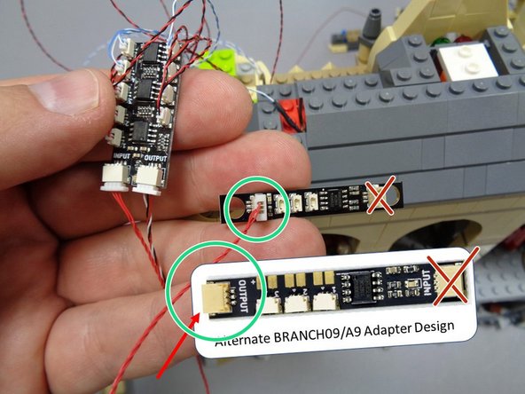 Take the two BRANCH09 adapter boards from Bag 10-- these are the adapters with three small plugs and two large plugs as shown in the first photo.