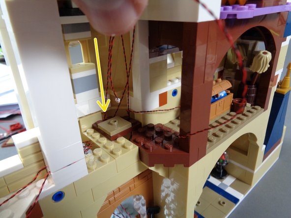 As shown by the yellow arrow in the third photo, pass the magic room light wire down below the spinning room floor.