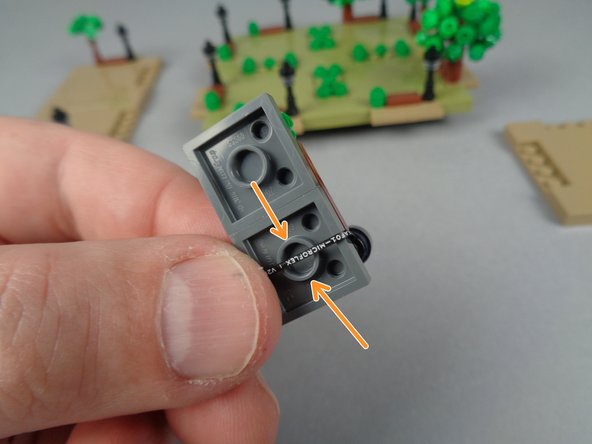 To prepare the base section for re-attachment, bend the LED wire under the base and make sure the wire passes directly OVER the center of the large tube underneath the plate.