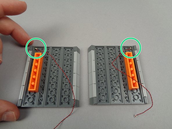 When you are finished, your setup should look like the third photo, with the two green roof lights positioned as shown by the two green circles in the photo.