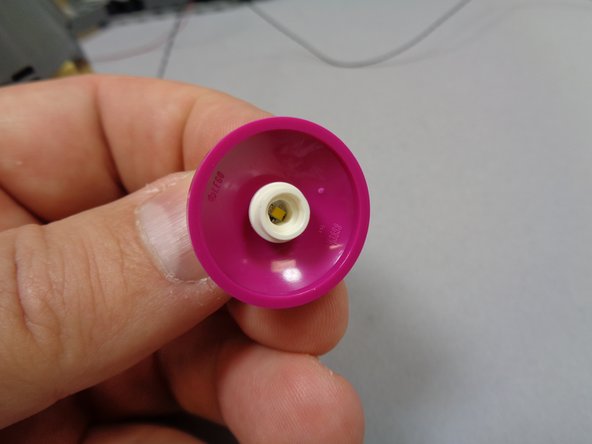 There should be a white round plate with hole in the center inside Bag 9.  Remove it, and place it on top of the light in the center of the dome as shown in the first photo.