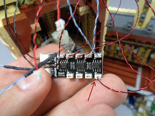 As shown by the red arrow in the first photo, connect the light from Dumbledore's office to plug #6 on the BRANCH09X adapter board.