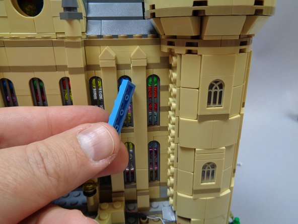 You will remove all of the light blue plates to make a &quot;channel&quot; for the torch wires to run up the side of the castle tower.  You will not need to use these light blue plates again.