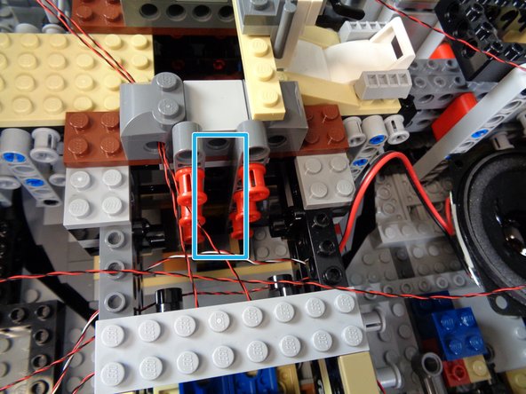 As shown by the red circle in the second photo, you can also run the light wires underneath plates and tiles.  Just make sure to run the wires between--not on top of--studs.