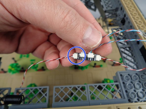 As shown by the blue circle in the second photo for this step, connect the end of the control cable coming from the first adapter board to the INPUT plug on the second adapter board.