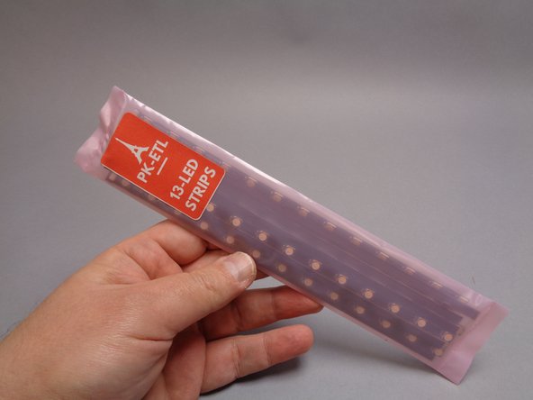 As shown in the first photo for this step, you will open the bag of 13-LED light strips next.