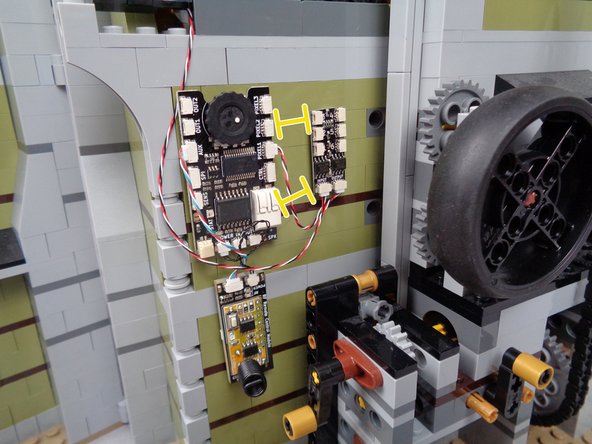 The photos in this guide show the BRANCH06X adapter board attached to the mansion back wall beginning in this step.  You can choose to wait to mount the BRANCH06X board until later if you wish-- waiting to mount the board will make it easier to connect the six LED lights to the board in the coming steps.