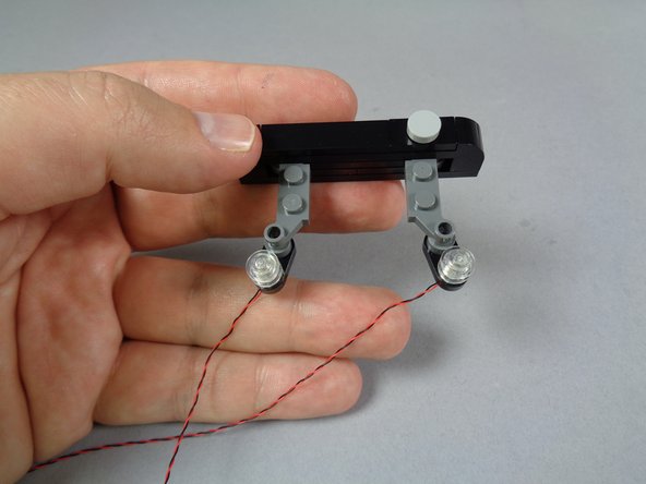 As shown in the first photo for this step, repeat the same process to mount the second strobe light.