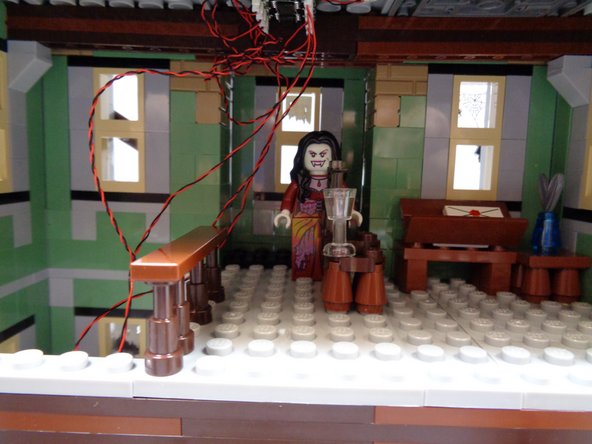 As shown in the third photo, carefully press the center floor section back into place.