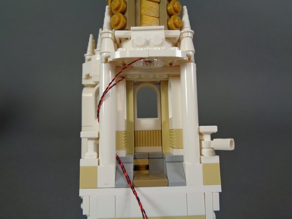 As shown in the second photo, wrap the two LED light wires around the pillar, then re-attach it to the ceiling.